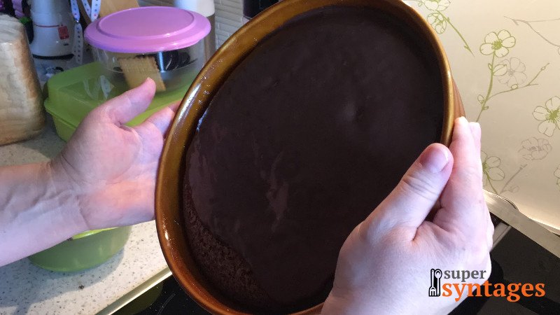 Απλώνουμε τη μερέντα σε όλο το κέικ ομοιόμορφα, απλά περιστρέφοντας λίγο το ταψί της σοκολατόπιτας